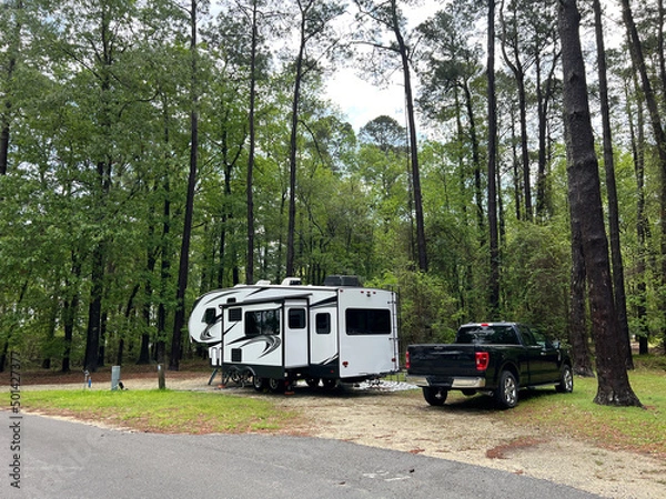 Fototapeta A fifth wheel rv set up for camping at the Santee State Park in South Carolina, USA.