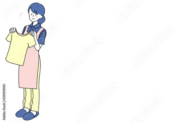 Fototapeta 洗濯物を広げる女性