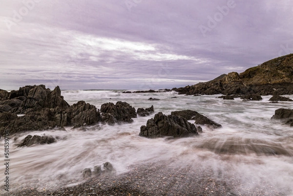 Obraz The rocks on this North Devon Beach are lapped by the sea on a cold November day.