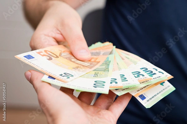 Obraz Counting money for a rent. Saving money concept. Finance, business, investment. Keeping savings at home. Spending cash for unexpected expense, unplanned losses, real estate, debts, taxes.