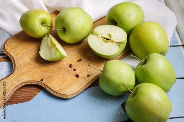Fototapeta Fresh raw green apples on the wooden background. Healthy food. Juicy fruits for all