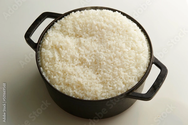 Fototapeta Ripe rice in a cast iron pot