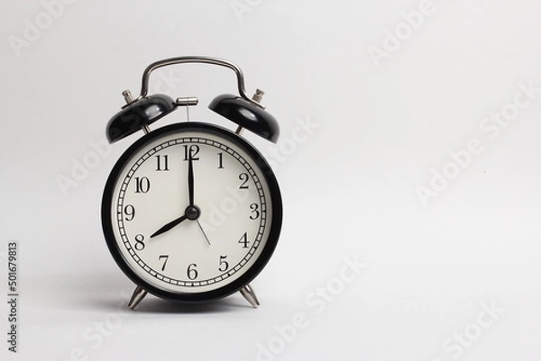 Fototapeta black vintage style alarm clock isolated on a white background