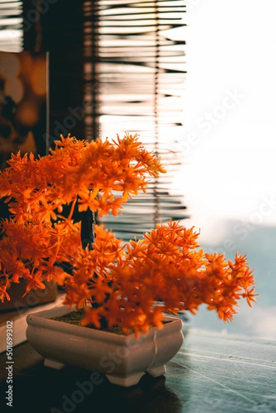 Fototapeta Orange artificial bonsai tree in Japanese restaurant with selective focus point