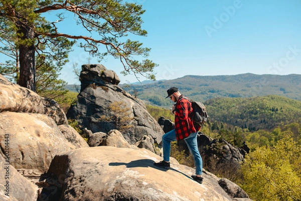Obraz man hiker with backpack at dovbush rocks