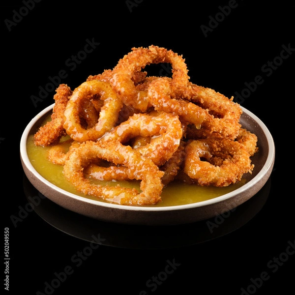 Fototapeta Squid rings in batter on a black background