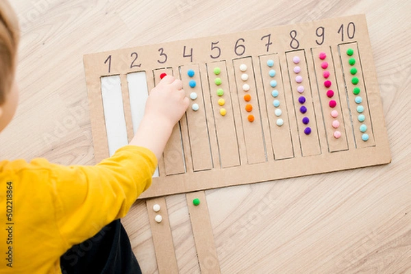 Obraz Put correct strap with balls of cotton wool to assigned cavity with number. Preschool educational aid for kindergartens. Children early learning montessori kit for intelligence.