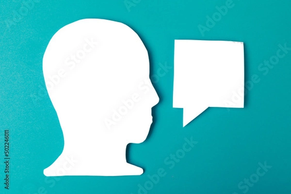 Fototapeta  paper face and speech bubble on colorbackground copy space for text, communication, symbolic- Image
