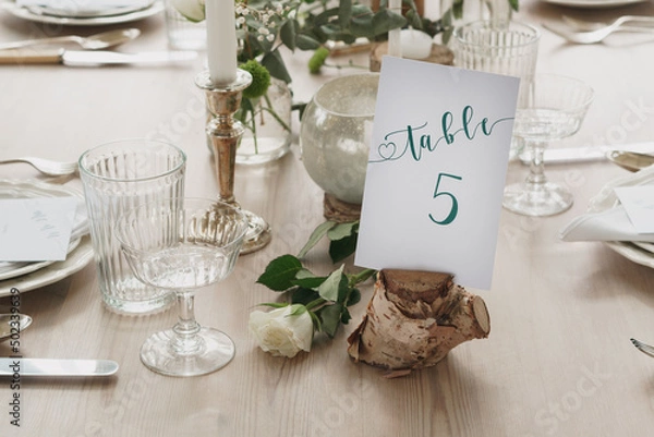 Fototapeta Wedding or party table decorations. Dining table set up in romantic rustic vintage style. Landscape shot of wedding or party meal table decorations and set up.