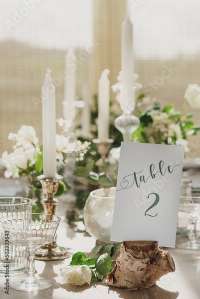 Fototapeta Wedding or party table decorations. Dining table set up in romantic rustic vintage style. Portrait shot of wedding breakfast set up.
