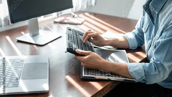Fototapeta Close up of hand asian woman programmer typing code data about new project with keyboard on laptop