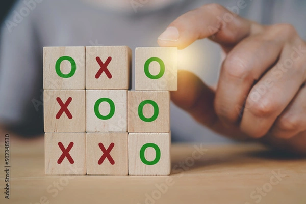 Obraz senior hand arranged wooden cube blocks, tic tac toe XO game, for business strategy, success concept