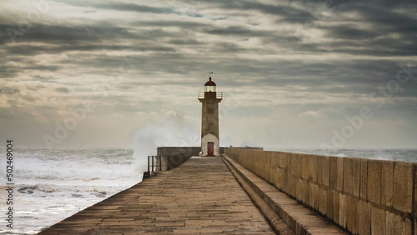 Fototapeta Lighthouse in Porto, Portugal, on a stormy day and big waves.
