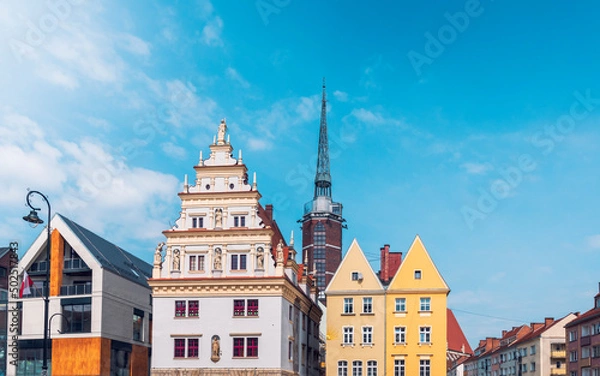Fototapeta .House of Municipal Scales on the market square in Nysa. In the background, the Tower of Mood, built in 2008, is a vantage point over the entire city. A beautiful renaissance tenement house in the com
