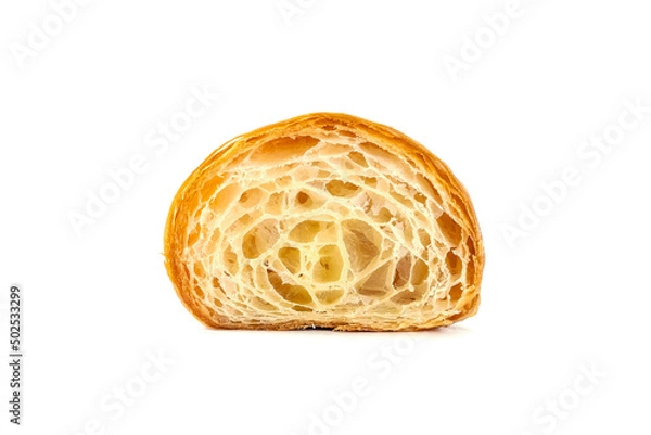 Fototapeta Plain Croissant cut in half, showing the cross section, a classic crescent-shaped croissant. isolated on a white background.