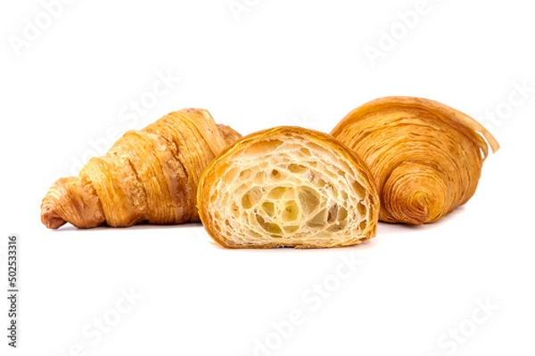 Fototapeta Plain Croissants and cut in half, showing the cross section, a classic crescent-shaped croissant. isolated on a white background.