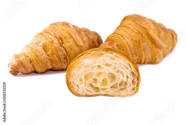 Fototapeta Plain Croissants and cut in half, showing the cross section, a classic crescent-shaped croissant. isolated on a white background.