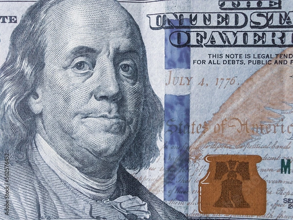 Fototapeta Part of the $100 close-up. US currency. Paper money. Cash. Dollar bills. A bundle of investments.