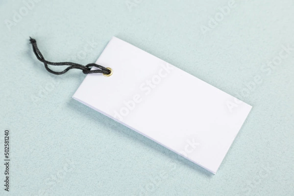 Fototapeta Empty white price tag on a gray-blue background with a soft shadow