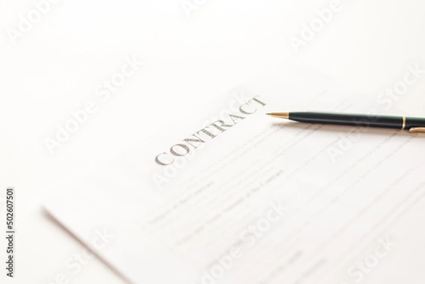 Fototapeta Green ballpoint pen on contract documets in office table