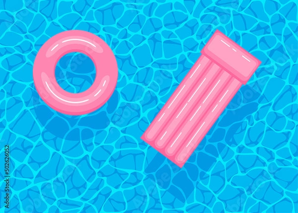 Fototapeta Swimming pool with floating inflatable pink circle and air mattress. Top view