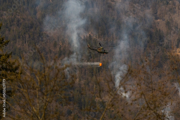 Obraz helicopter in flight putting out fire