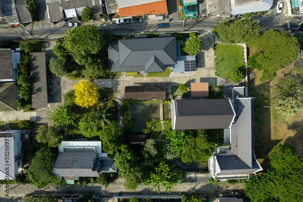 Fototapeta Aerial view of the roof of a house with a car taken by a drone, top view of road