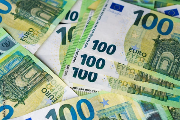 Fototapeta Lot of paper one hundred euro banknotes for bachground. Top view on heap of money