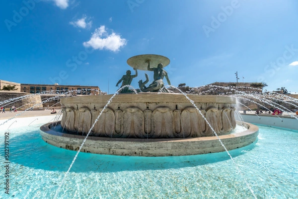 Fototapeta Famous fountain with three sculptures holding a disc on suburbs of Valletta.