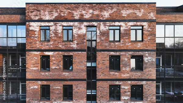 Fototapeta A new brick house stained with white efflorescence, a crystalline of salt, formed due to water being present in the bricks. Construction defects