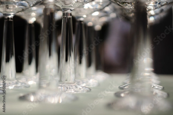 Fototapeta row set of empty wineglasses in restaurant bar