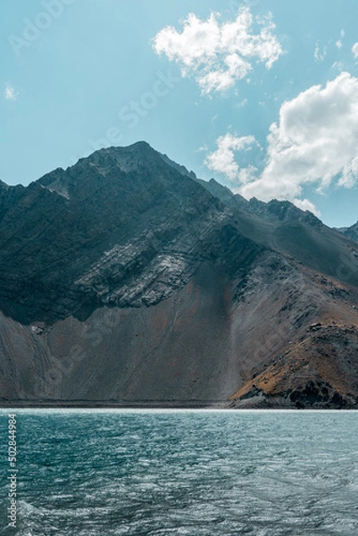 Fototapeta Vertical shot of turquoise water in the Embalse del Yeso reservoir with colored mountains in the background, Chile.