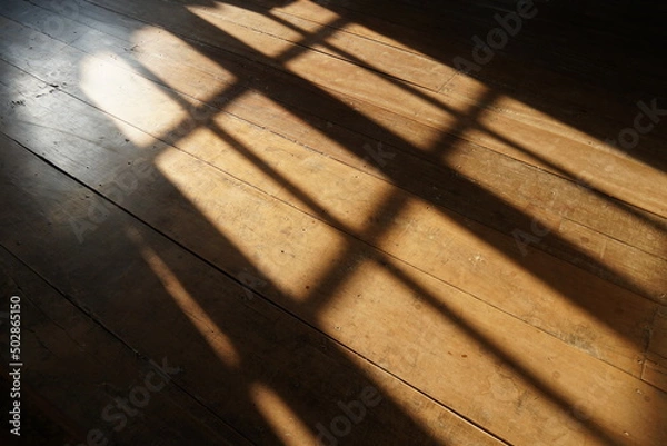 Fototapeta sunshine in morning through windows with shadows on wooden floor old background