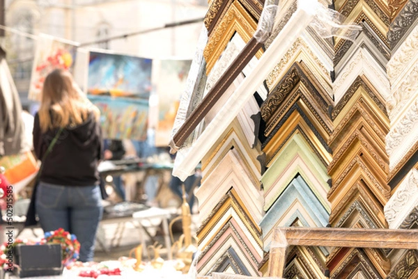 Fototapeta Many wooden and plastic picture frames in different colours and sizes. Custom picture and arts framing service. Crafts fraiming workshop