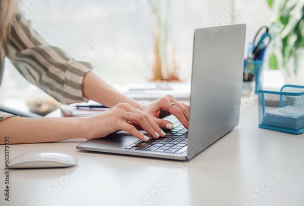 Fototapeta Young woman working on a computer