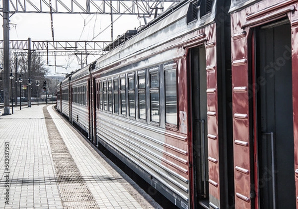Obraz suburban electric train at the platform at the railway station close-up in spring