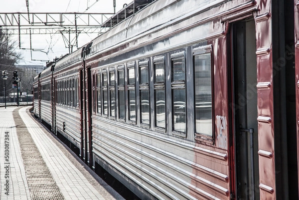 Obraz suburban electric train at the platform at the railway station close-up in spring