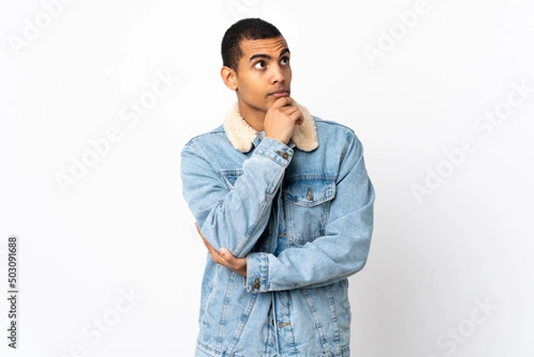 Obraz African American man over isolated white background thinking an idea while looking up