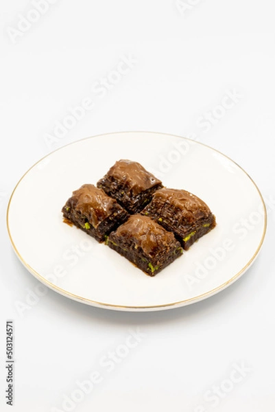 Fototapeta Chocolate baklava. Chocolate baklava with pistachio isolated on white background. Mediterranean cuisine delicacies. Close-up. local name cikolatali baklava