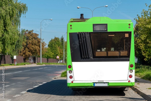 Fototapeta Modern green and white bus with blank white space for advertisement