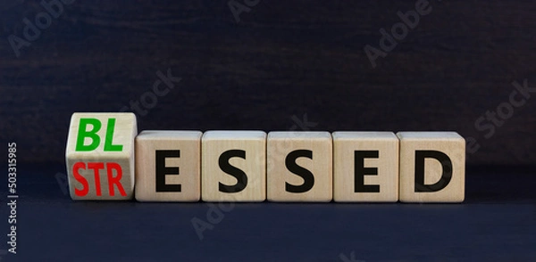 Fototapeta Blessed or stressed symbol. Turned wooden cubes and changed the concept word Stressed to Blessed. Beautiful black table black background. Business blessed or stressed concept. Copy space.