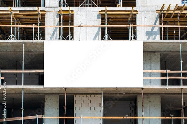 Obraz Blank white banner for advertisement on the facade of building under construction