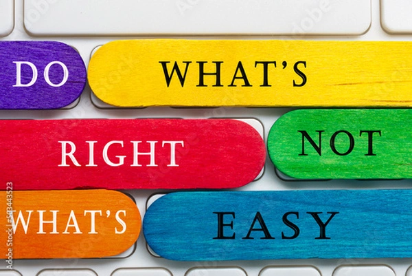 Fototapeta Colorful wooden sticks with word on a white keyboard. Motivational quote.