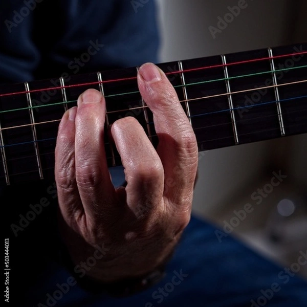 Obraz Closeup of hands playing a guitar