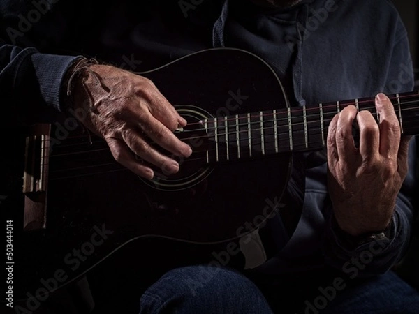 Obraz Closeup of hands playing a guitar