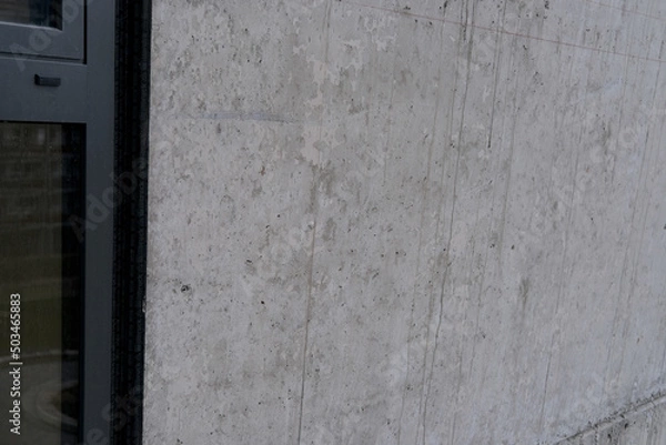 Fototapeta concrete gray wall of an architectural building, building material, texture for a designer
