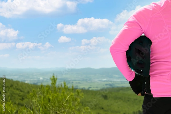 Obraz Person holding bicycle helmet