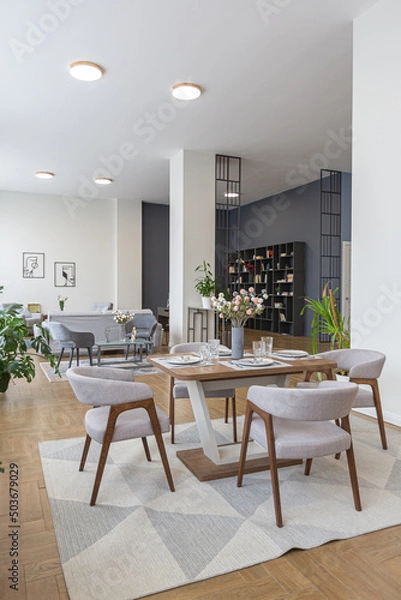Obraz dinnig and kitchen area in minimalist modern interior design huge bright apartment with an open plan in Scandinavian style in white, blue and dark blue colors with columns in the center