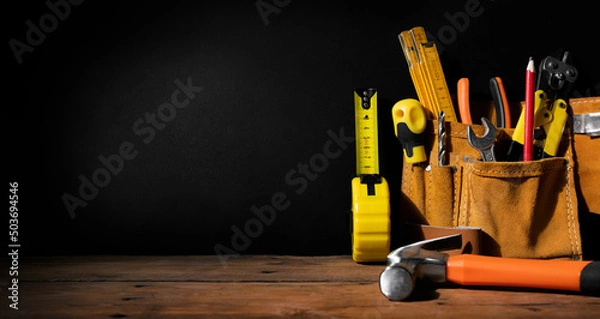 Fototapeta home improvement - construction tools on black background with copy space. banner
