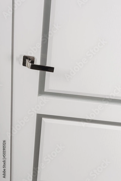 Fototapeta Modern chrome door handle on white bright door